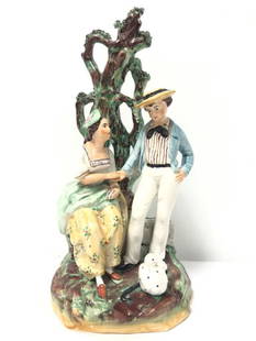 EARLY 19TH C ENGLISH STAFFORDSHIRE PORCELAIN FIGURE: Early 19th century English Staffordshire porcelain figurine depicting a man (boatswain) and woman. Measures 11.75" tall x 5.75" wide. Unsigned. Condition: very tiny loss to applied leaves on the very