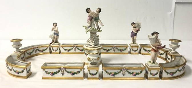 ITALIAN CAPODIMONTE PORCELAIN SURTOUT DE TABLE 16P: Italian Capodimonte sixteen piece porcelain surtout de table. Includes a central double cherub figurine, and fifteen additional pieces: miniature planters staggered with pedestal urns and cherub
