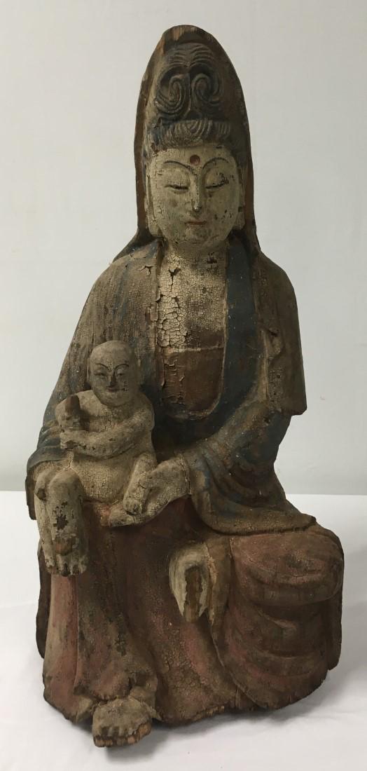 CHINESE CARVED WOOD SCULPTURE: GUAN-YIN WITH CHILD: Chinese carved wood sculpture depicting Guanyin with child. Measures a total of 25" tall x 12" wide and 11" deep. Remnants of a seal at the tip of Guanyin's headdress. Condition: scattered losses and 