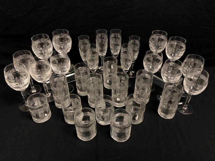 RALPH LAUREN "GLEN PLAID" CRYSTAL DRINKWARE 31 PCS: Ralph Lauren "Glen Plaid" crystal drinkware set. Includes (7) 6.2" tall highball glasses, (6) 8.75" water goblets, (6) 8.2" wine glasses (one with tiny flake to rim), (6) 4.2" tall old fashioned glass