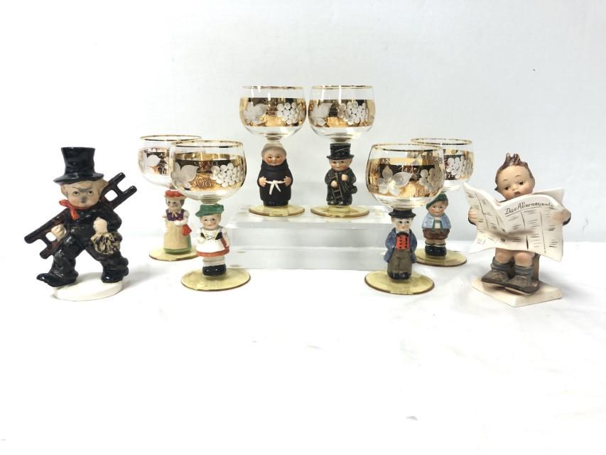 HUMMEL GOEBEL FIGURINES & WINE GLASSES, TMK 1, ETC: Lot of assorted Goebel Hummel figurines and figural wine stem glasses. Includes a rare Goebel Chimney Sweep K.F. 38 Trademark 1- Incised crown, Hummel 184 Latest News Trademark 2, and a set of six Hum