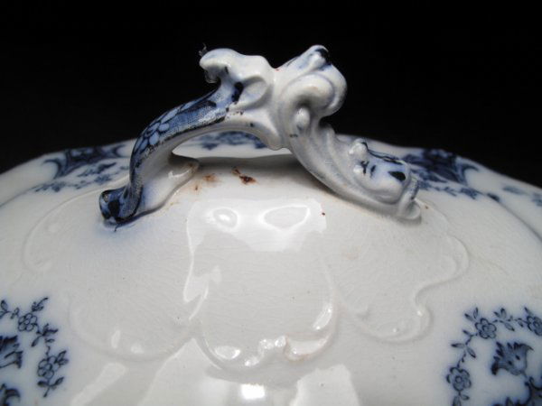 ANTIQUE ENGLISH FLOW BLUE & WHITE CERAMIC TUREEN: Antique English flow blue and white transfer decoration tureen with underplate. Circa 1900 by Adderly in the "Malta" pattern. Tureen is 11 1/2" wide and 6" high. Oval under plate measures 12" x 9 1/2"