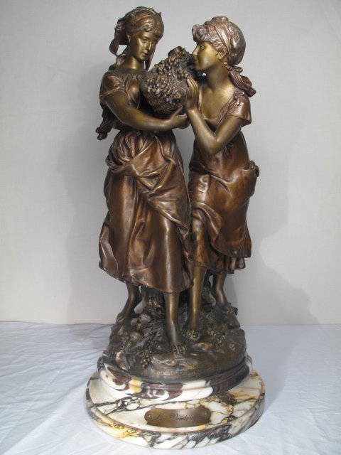 ANTIQUE SPELTER STATUE AFTER MOREAU "LES VENDAGES": Antique spelter or French metal statue of two women after Moreau. Circa 1890. Statue has a foundry stamp and rests on an attractive marble plinth. Height: 23". Diameter of base 11 1/4". Total weight: 