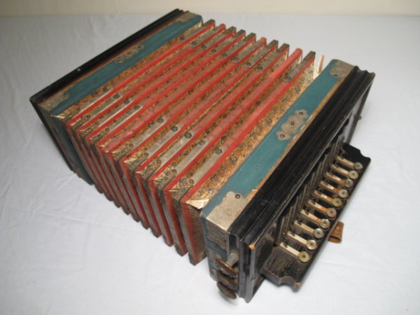 ANTIQUE BEAVER BRAND GERMAN ACCORDION: Antique Beaver brand accordion, late 19th Century. Made in Germany. Frame is made from ebonized wood. Bellows are fabricated from paper with metal mounts. Unextended width: 14 1/2". Height: 13 1/2". W