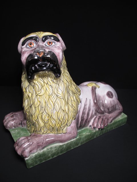 DECORATIVE HAND PAINTED ITALIAN CERAMIC LION: Decorative hand painted stylized Italian ceramic lion. Second half of the 20th Century. Sponged base and freehand painted body and mane. Length: 17". Width: 9 1/2". Height: 14". Weight: 8.3 lbs. Condi