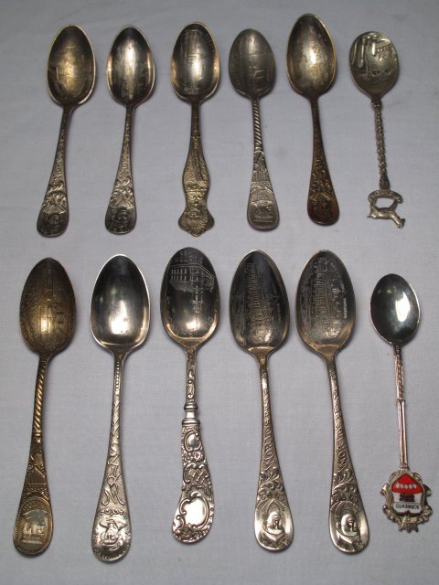 TWELVE ANTIQUE SOUVENIR SPOONS WORLDS FAIR MAINE: Twelve silver plated souvenir spoons, most antique, some from the Columbian Exposition of 1892 and the sinking of the U.S. battleship 'Maine' in Havana harbor in 1898. Also included in the lot is a .8