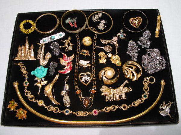 OVER FORTY PIECES VINTAGE & OTHER COSTUME JEWELRY: Over forty pieces of vintage and other costume jewelry, many signed, including brooches, bracelets, and earrings. Designers include: J.J., Trifari, and Boucher. Most gold-toned. Total weight: 1.3 lbs.