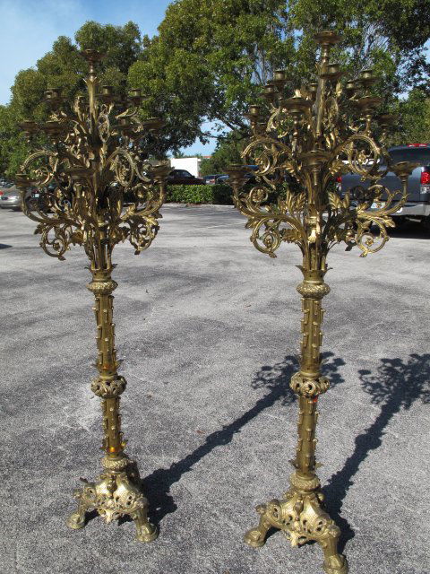 TWO GOTHIC ANTIQUE CHURCH STANDARD CANDELABRA: Two antique brass church standing candelabra, late 19th Century, probably continental European, in the Gothic Revival style. Each candelabrum has eighteen elaborate branches and one central candle hol