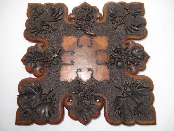 HEAVILY CARVED ANGLO INDIAN WOOD OCCASIONAL TABLE: Antique carved wood Anglo-Indian occasional table, circa 1900. Collapsible table is decorated all over with relief carving of mainly botanical motifs. Table top measures approximately 26 1/2" x 26 1/2