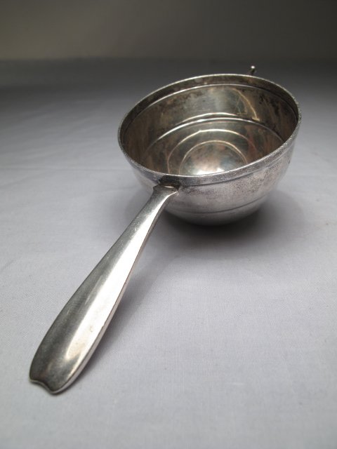 TIFFANY & CO STERLING SILVER MEASURING CUP: Tiffany and Company sterling silver measuring cup. First half of the 20th Century. Used for measuring liquids, especially liquor. Length of jigger: 5 1/2". Height of bowl: 1 5/8". Approximate troy wei