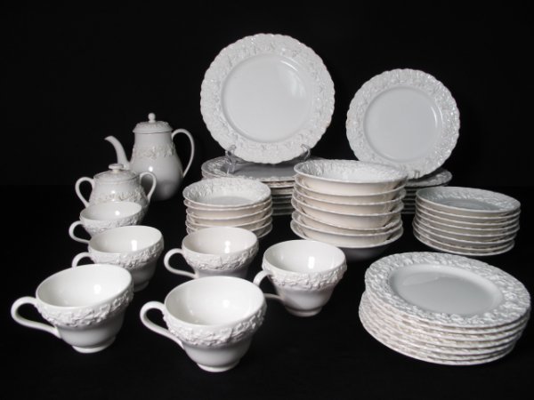 53 PCS WEDGWOOD ETRURIA EMBOSSED QUEENSWARE CHINA: Vintage Wedgwood Etruria part dinner service in the "Embossed Queensware" pattern. Circa mid 20th Century. Including: 8 dinner plates (diameter: 10 1/4"); 8 salad plates (dia: 8 1/2"); 7 bread plates 