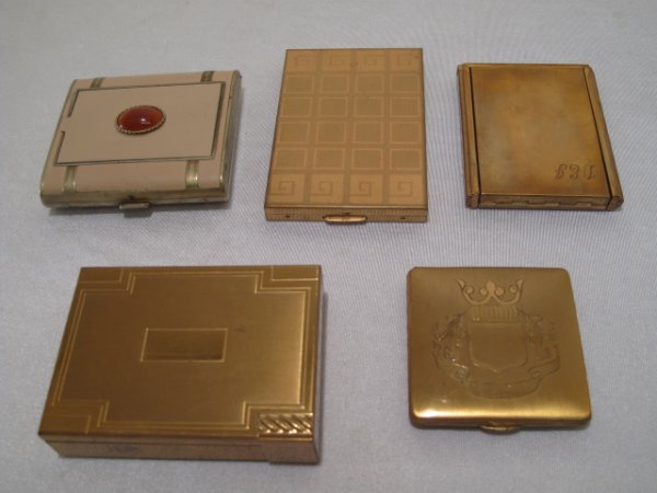 FIVE VINTAGE METAL LADIES POWDER COMPACTS VOLUPTE: Five vintage ladies powder compacts, the largest marked "Volupte". All mid 20th Century. Largest measures 3 1/4" x 2 1/4" x 3/4" thick. Total weight: 1.4 lbs. Condition: good with minor wear.