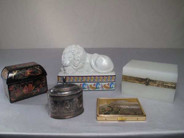 FIVE DECORATIVE BOXES GLASS RUSSIAN PORCELAIN: Five decorative boxes including an opaque glass box, a painted Russian lidded box, a ceramic lion box and three metal boxes, one a Japanese cigarette case with a mixed metal image of Mount Fuji. Large