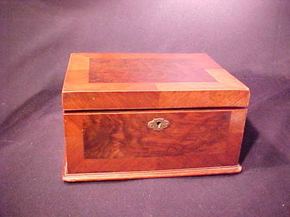 OLD MAHOGANY INLAY TRINKET BOX 9" wide b: OLD MAHOGANY INLAY TRINKET BOX 9" wide by 7" deep and 4 1/4" tall. Lock mechanism works. Some scratches. Chip to molding right and left front corner and left rear corner.