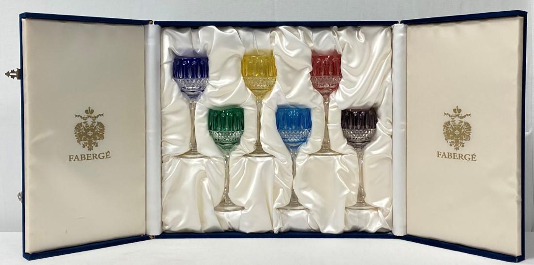 SIX FABERGE "XENIA" COLORED CRYSTAL WINE HOCKS: Lot of six Faberge "Xenia" crystal cut to clear wine hocks / stems. All held in original blue velvet lined presentation box. Each stem measures 8.25" tall and is signed on base. Condition appears to b