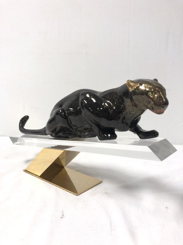 GIULIA MANGANI FOR OGGETTI: PANTHER ON LUCITE: Giulia Mangani for Oggetti: painted porcelain panther sitting atop a lucite and brass base. Signed under panther's tail "Mangani", and marked with sticker Oggetti label on lucite. Measures a total of