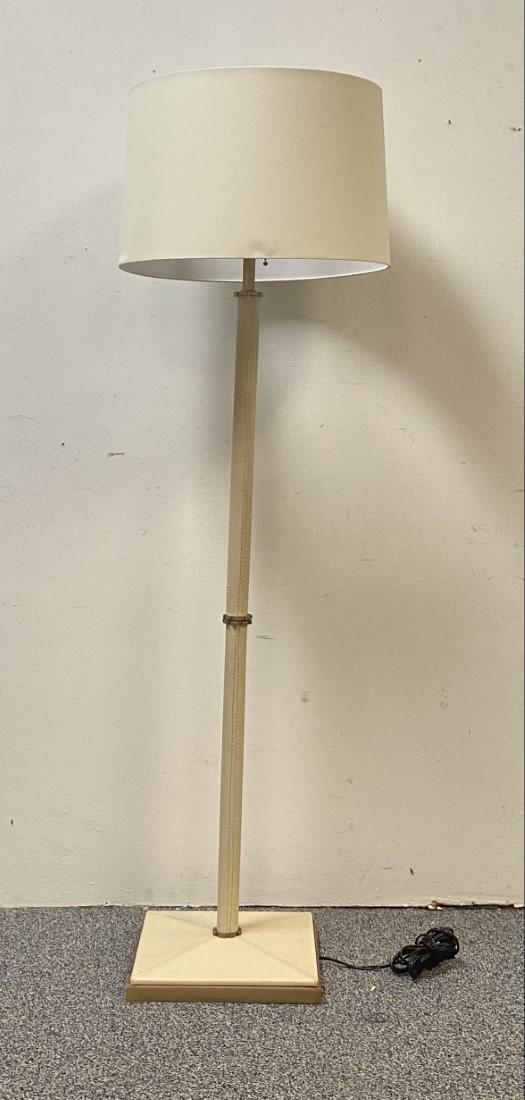 OFF-WHITE LEATHER & BRASS FLOOR LAMP: Off-white leather and brushes brass floor lamp measuring a total of 58" tall x 12.5" wide at base. Shade measures 10.75" tall x 16" diameter. Condition: minor signs of handling and soiling to shade, s