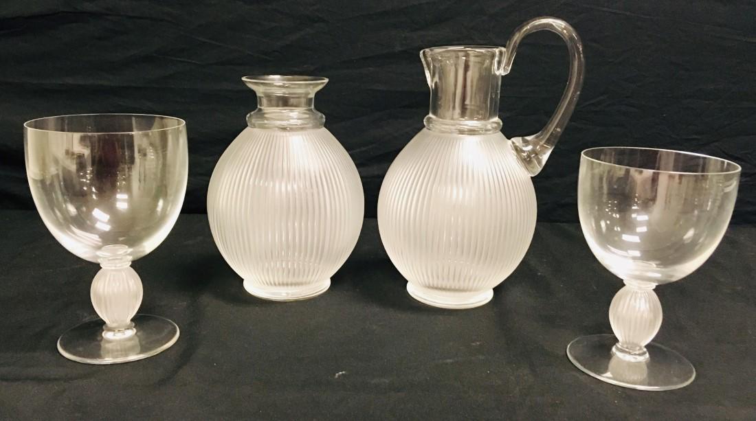 LALIQUE "LANGEAIS" PITCHER, DECANTER & TWO STEMS: Lot of four pieces of Lalique "Langeais" crystal ware. Includes a 9-3/4"" tall pitcher, 7" tall decanter (no stopper), 5-1/8" tall water goblet, and 5-5/8" tall wine glass. Each piece signed on base. 