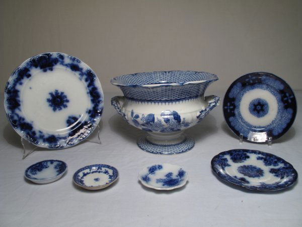 SEVEN PIECES ANTIQUE FLOW BLUE & WHITE TABLE WARE: Seven pieces of antique flow blue and transfer printed ceramic table ware. Lot includes six plates (largest diameter: 8 1/2". Smallest diameter: 3"); and a Cauldon, England tureen in the "Ruskin" patt