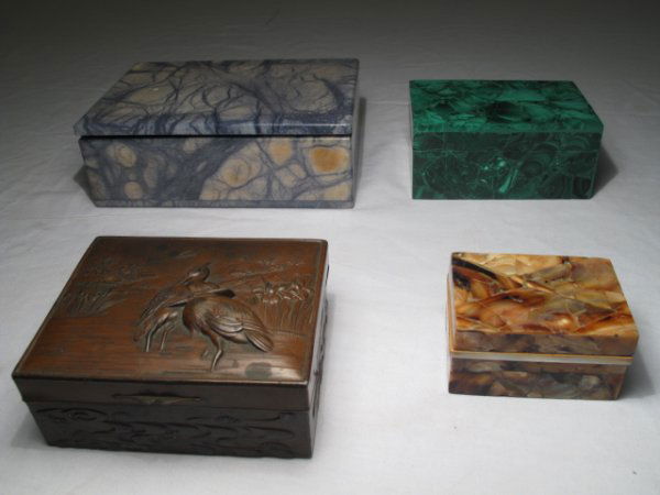FOUR DECORATIVE BOXES MALACHITE ALABASTER ITALY: Four decorative table top boxes including a malachite box, a blue stained alabaster box, a patinated spelter Japanese box, circa 1920, and a mother-of-pearl veneered box. Largest box measures 6 1/4" x