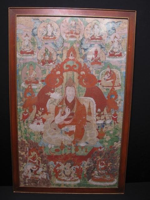 ANTIQUE FRAMED TIBETAN BUDDHIST THANKA: Antique framed Tibetan Buddhist thanka, probably late 18th or early 19th Century. Hand painted with gold highlights. Revealed image measures 26 1/2" x 16". Frame measures 28 1/2" x 18 1/4". Weight: 6.
