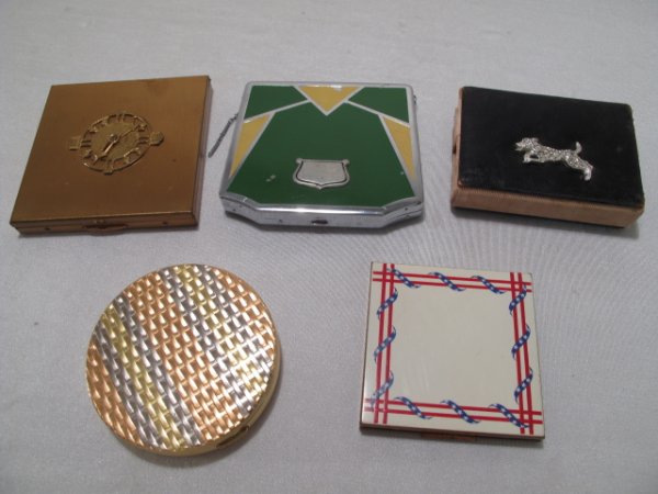 FIVE VINTAGE LADIES METAL COMPACTS MAJESTIC: Five vintage ladies metal compacts including one signed, "Majestic". All mid 20th Century. One with an angular Art Deco design, circa 1930. Largest measures 3 1/4" x 4 1/4". Smallest measures 2 1/4" x