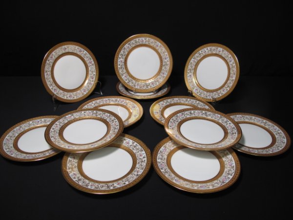 TWELVE ANTIQUE LIMOGES GILDED PORCELAIN SIDE PLATE: Twelve antique Limoges, France two-tone gold gilded porcelain side plates on a white ground ornamented with floral sprays. Late 19th Century. Manufacturer: William Guerain & Co., Limoges. Each plate i