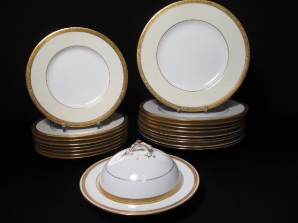 NINETEEN MIXED PLATES MINTONS IVORY WHITE & GOLD: Nineteen assorted pieces of Mintons china with a variety of gilt borders, including a white and gilt butter dish. All first half of the 20th Century. Larger plates measure approximately 10 1/2" in dia