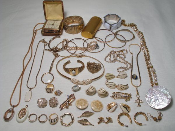 OVER FORTY PIECES OF COSTUME JEWELRY MONET NAPIER: Over forty pieces of vintage and other costume jewelry, mainly gold tone. Lot includes pieces signed Monet and Napier as well as an alarm clock signed Bradley, made in France. Various styles including