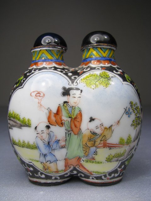 CHINESE ENAMEL DOUBLE SNUFF BOTTLE: 20th century Chinese enameled double snuff bottle. Hand painted scenes on the front and back panels depicting children playing and a floral design on the sides. Chinese characters on the base of each 