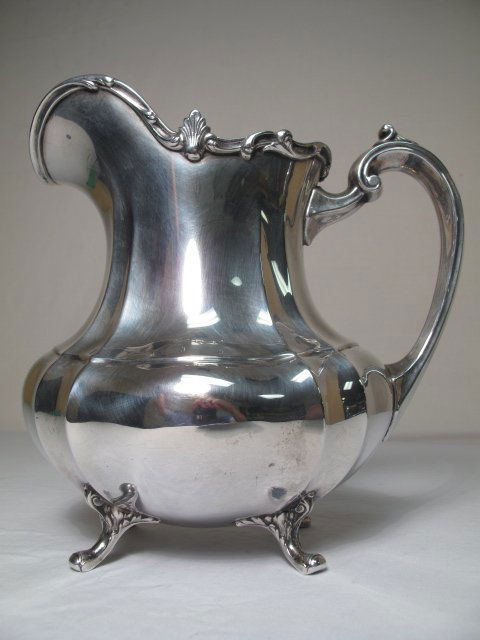 REED AND BARTON STERLING SILVER PITCHER HAMPTON CO: Reed and Barton sterling silver pitcher in the Hampton Court pattern. Measures 9" tall by 9" wide spout to handle and 5" wide at body. Stamped, "Reed & Barton, STerling 660 Hampton Court 8 H.P." Condi