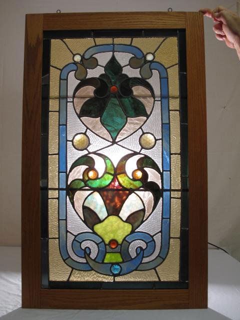 ANTIQUE LEADED GLASS WINDOW PANE CRANBERRY OPALINE: Antique leaded glass window pane with textured glass, slag glass, and cranberry and opaline glass rondels. 19th Century. Mounted in a later frame with some restorations. Frame measures 36 1/2" x 22 1/