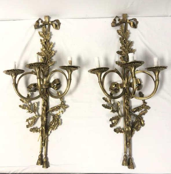 PAIR LOUIS XVI STYLE GILT BRONZE TRUMPET SCONCES: Pair of Louis XVI style gilt bronze trumpet form sconces. Each one measuring a total of 36" tall x 17.5" wide and 9.75" deep from the wall. Condition: wired and untested, may need rewiring for safe us