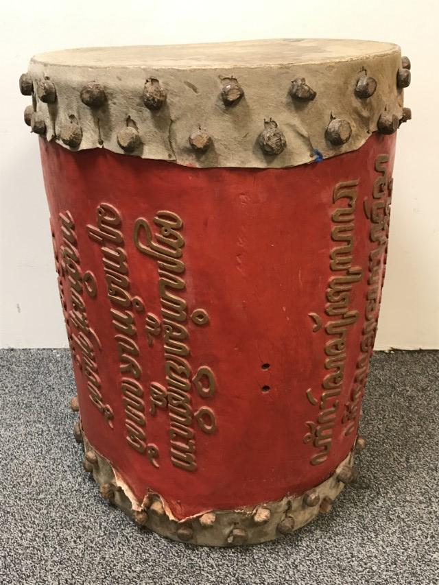 TRADITIONAL TAMIL WOOD AND LEATHER DRUM: Traditional Tamil wood and leather tribal drum measuring 31.5" tall x 24.5" diameter. Condition: minor signs of use and age, may have some missing pegs, see images. Weight: approx. 55 lbs.