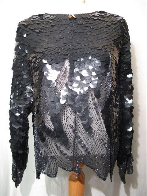 VINTAGE BLACK BEADED AND DISC EVENING TOP: Vintage black beaded and disc evening top. All over black disc design with sheer beaded handkerchief edge sleeves and hem. Size medium. Generally good condition. Shipping weight 5 lbs.