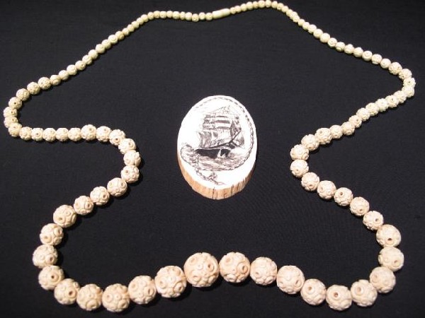 2 PCS IVORY BEADS SCRIMSHAW PENDANT WHALING SHIP: Two-piece jewelry group including an antique carved ivory or bone bead necklace, 36" in length, and a scrimshaw on ivory pendant with a whaling ship scene, 3" x 2 . Weight: .3 lbs. Condition: good