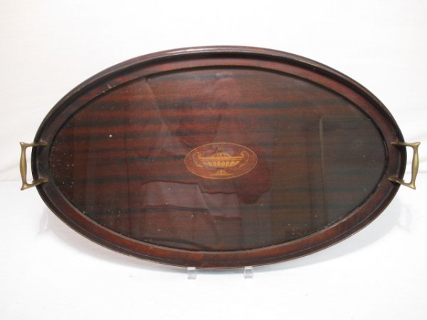 MAHOGANY FEDERAL STYLE HANDLED TRAY WITH INLAY: A mahogany two handle stray in the Federal style with brass handles and center medallion inlay depicting an urn. Glass cover. Tray measures 24" x 14 1/2". Condition good but for a small wave on the in