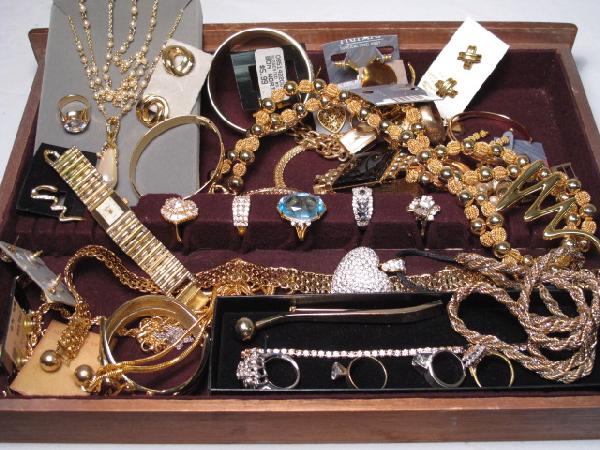 ASSORTED COSTUME JEWELRY NOLAN MILLER SMB STERLING: Tray lot of assorted costume jewelry. Some signed, some unsigned. Mostly new. Includes Nolan Miller, SMB, Sterling rings, gold plated rings, Monet, Quartz, 10k gold ring, gold and silver tone jewelry,