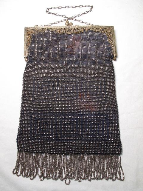 VINTAGE BEADED LADIES PURSE ON SILVER FRAME: Vintage beaded ladies purse on silver frame. Inside lining needs to be replaced. No apparent loss of beading on exterior. Bag measures 9 1/2" inches to bottom of fringe x 6" wide. Weight is 4 ounces.