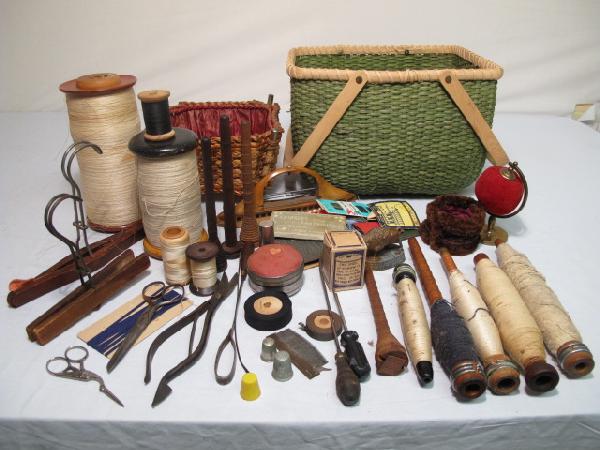ANTIQUE AND VINTAGE SEWING NOTIONS AND TOOLS: A large assortment of antique sewing goods from the mid to late 1900's. Includes: large and small wood thread spools, various tools, old wood hangers, needles, scissors and much more. All in generally