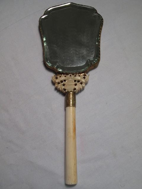 ANTIQUE CHINESE CARVED STONE & IVORY HAND MIRROR: 19th century Chinese hand mirror with Ivory handle and light green stone back with mixed stone carvings in a leaf and grape design with a small squirrel on upper left corner. Some losses to stones. Se