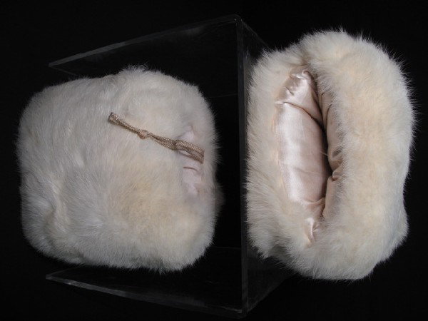 2 VINTAGE WHITE FUR HAND MUFFS: 2 Vintage white fur hand muffs. Both lined in very good condition. One is 8 inches wide, the other 7 inches wide. Shipping weight less than a pound.