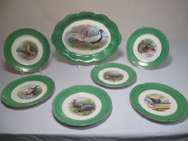 GREEN GILT CHINA GAME MEATS PLATE SET SIGNED: 19th/early 20th century green & gilt china game meats plate set signed R.K. Beck. Includes 6 plates and a serving platter. Plates measure 9.25". Platter measures 15" x 11.5". One plate has a hairline 