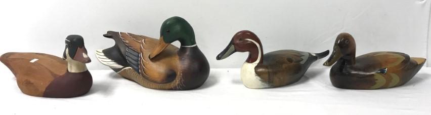 HAND-PAINTED WOOD DUCK DECOYS, 4: Lot includes: 1 Ducks Unlimited decoy, L 14", signed by K.W. White, #2487; 1 French Broad River decoy, L 14"; 2 older, unmarked handmade decoys, L 16" and 14". Condition: some wear, loss of pant and