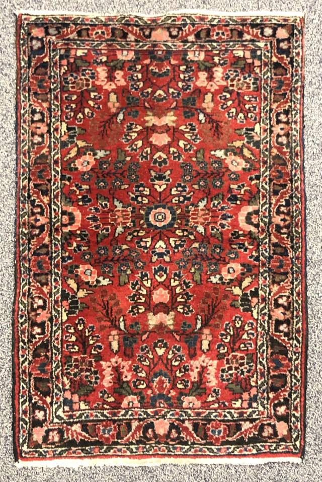 LILLIHAN WOOL RUG, SEMI-ANTIQUE, 4' X 2' 6": Persian, red ground, semi-centralized overall spray design, 3 floral borders, Avakian Bros. Inc. label. Condition: some knots showing particularly around the edges, loss into outer edging at one end,