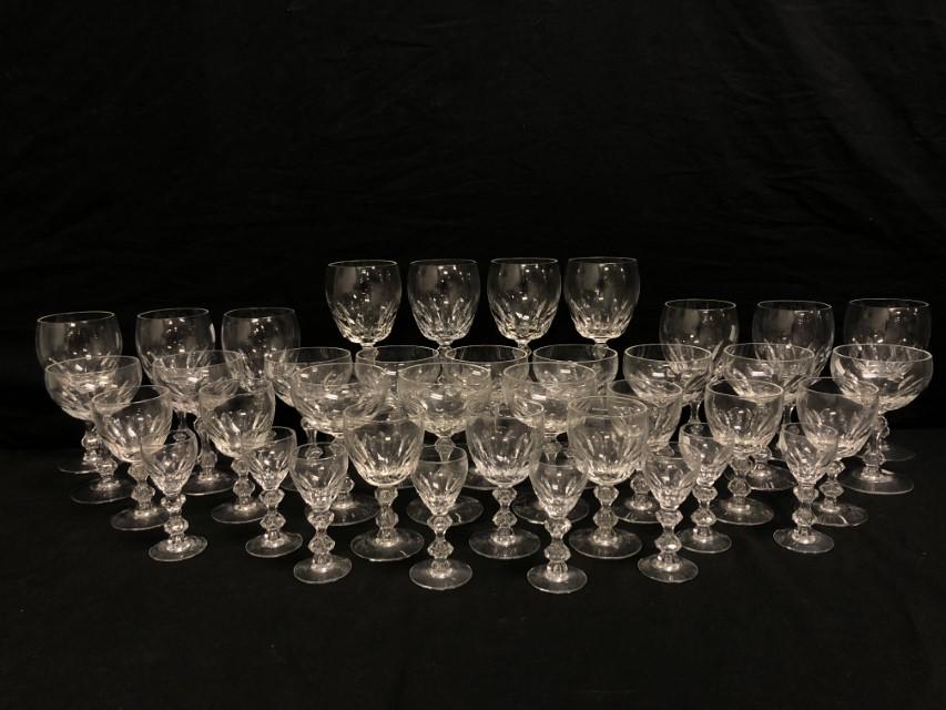 TIFFIN-FRANCISCAN "MANCHESTER" CRYSTAL STEMWARE: Tiffin-Franciscan "Manchester" pattern crystal stemware. Includes (10) 7" water goblets, (12) 5-3/8" champagne/tall sherbet glasses, (8) 5" wine glasses, and (8) 4" cordials. Unsigned. Condition: good