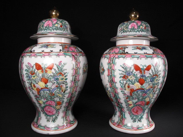 PAIR CHINESE ROSE MEDALLION GINGER JARS: 20th century Chinese ginger jars in the Rose Medallion pattern. On carved wooden stands. H. 17". Good condition, some very minor paint loss. Shipping weight 11 lbs.