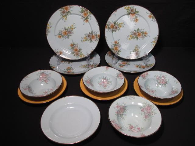 MACKENZIE CHILDS PLATES / BOWLS: VICTORIA & RICHARD: MacKenzie Childs plates and bowls in the Victoria and Richard pattern. Includes 4 blue enamel floral and gilt 12" plates, 4 blue enamel floral and gilt 7.5" bowls, 3 yellow enamel gilt 9" soup bowls, 