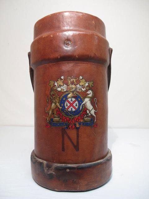 LEATHER FIRE BUCKET: An English Leather fire bucket with handle, applied coat of arms and embossed "N". Lined on the inside with fabric, see images .Good condition, has some burn marks on the outside, as well as scratches