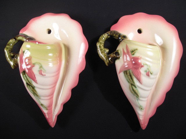 PAIR HULL ART POTTERY WALL POCKETS: Pair of Hull art pottery wall pockets. Made to look like sea shells with a floral painted design. Marked "HULL" on bottom. Good condition, see images. Measures 8" tall x 5.75" wide. Shipping weight 1.